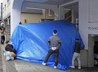 シートで覆われた郵便受け。捜査員らが中を調べた＝２１日午後１時３９分、神戸市中央区中山手通６