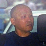 捜査車両に乗せられて長田署を出る菱川龍己容疑者＝２４日午前９時４０分、神戸市長田区北町３