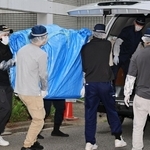 遺体が見つかった部屋から押収物を運び出す捜査員ら＝６月２２日、神戸市中央区中山手通６