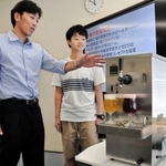 ホットビールサーバーの特徴を説明する精和工業所の原克彦社長（左）＝神戸市西区伊川谷町