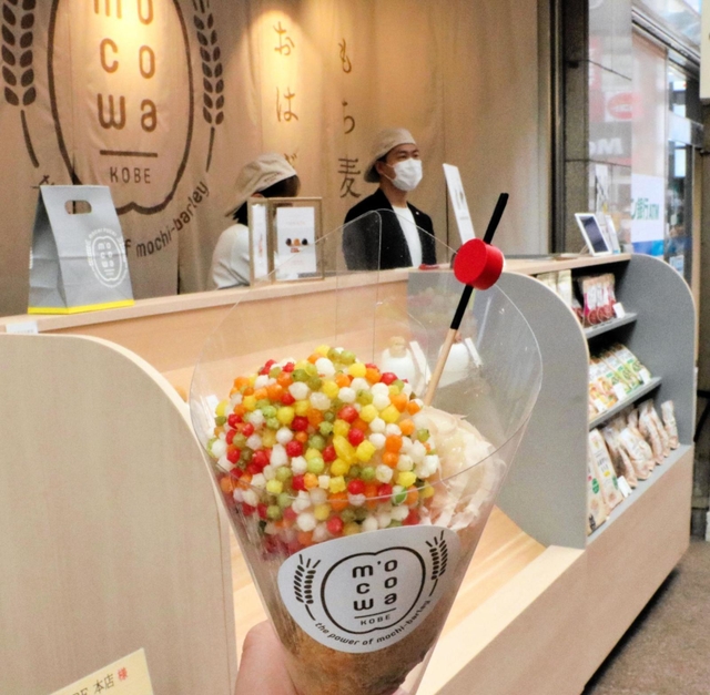食べ歩き用カップに入ったもち麦入りのおこわと、５日にオープンする店舗＝神戸市中央区三宮町３