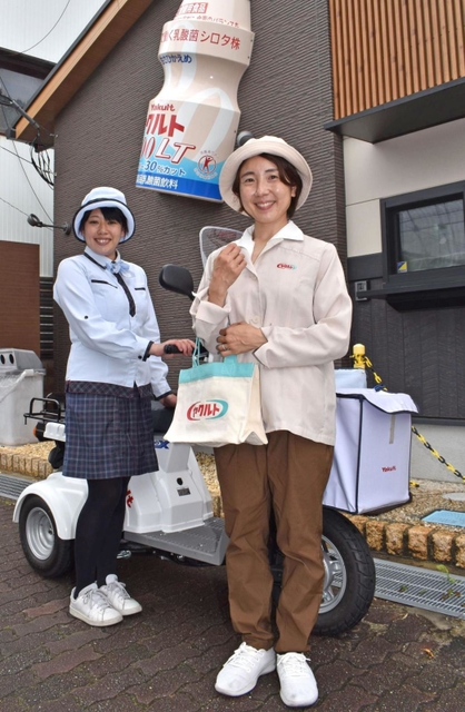 復刻した６０年前の制服（右）と、現在の制服を着用するヤクルトレディの２人＝明石市材木町、兵庫ヤクルト販売の「時のまち明石ステーション」