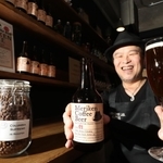 香り高くフルーティーな味わいの「メリケンコーヒービール」を手にする大西賢さん＝神戸市灘区水道筋６