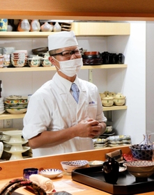 料理の説明をしたり、世間話をしたりする曽根康弘さん＝神戸市中央区下山手通２