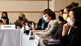 担当する国の意見や利害を念頭に置きながら議論を進める学生たち＝神戸市中央区