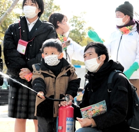 消火器の使い方を学ぶ親子＝神戸市中央区脇浜海岸通１