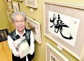 タイトルにも採用した作品「撓」を前に、作品集を手にする小畑延子さん＝東京都中央区