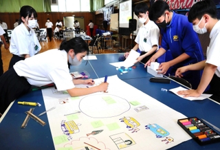模造紙にどんどんアイデアを書き込んでいく唐櫃中の生徒たち＝神戸市北区唐櫃台４
