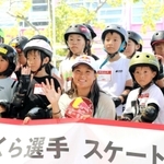 スケートボード体験教室に参加した小学生たちと笑顔で記念撮影に納まる四十住さくら選手（手前中央）＝神戸市東灘区向洋町中８、ジースケートパーク