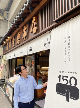 創業の地に立つ店を受け継いだ５代目店主、松井隆昌さん＝中央区元町通６