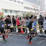 鉄人２８号のモニュメント前を走り抜けるランナーに声援を送る人たち＝１９日午前、長田区若松町６