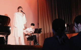 神戸市立鷹取中学校３年生に向けてエールを送る歌手のｅｒｉｃａさん＝神戸市須磨区行幸町２、兵庫大付属須磨ノ浦高校