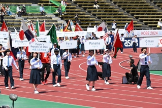 選手に加え、西落合中の生徒らが旗とプラカードを持って行進した開会式＝ユニバー記念競技場（撮影・大田将之）