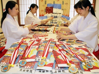 七五三祝いの千歳飴を袋に詰める巫女ら＝生田神社