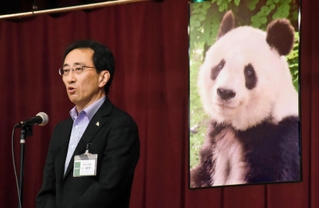 優しい表情をしたタンタンの写真の前で、ファンに感謝を述べる加古裕二郎園長＝灘区王子町３、動物園ホール