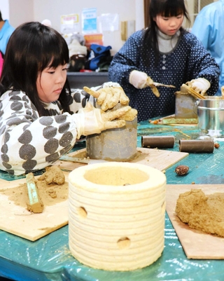 阪神・淡路大震災３０年の催しで使う土灯籠を手作りした＝田中公会堂