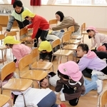 椅子の下に入って身を守る園児ら＝神戸市中央区吾妻通４