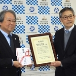 神戸市社会福祉協議会から感謝状を贈られた世良美術館の濱崎庄一館長（右）＝こうべ市民福祉交流センター