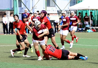 ボールを持って駆け出す甲南の選手に必死で食らいつく灘高の選手＝灘中学・高校