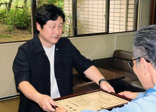 中村信幸署長（右）から感謝状を受け取る坂本真司さん＝兵庫県警生田署
