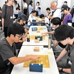盤上で熱戦を繰り広げる参加者＝神戸市中央区東川崎町１、神戸新聞社