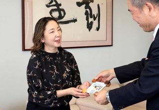 神戸新聞社の梶岡修一社長から記念盾を受け取る松下麻理さん（左）＝神戸新聞社（撮影・吉田敦史）