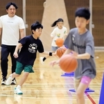 バスケットボールでドリブルの練習をする子どもたち＝王子スポーツセンター