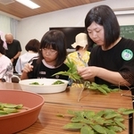 エノキの葉を数える参加者たち＝神戸市立森林植物園