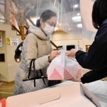 明石海峡でつり上げられた焼き鯛を受け取る市民＝道の駅みき