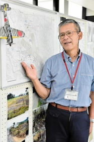 三木飛行場の地図を見ながら当時の状況を説明する宮田逸民さん＝三木市立中央図書館
