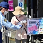 啓発グッズを配布する三木署員ら＝三木市志染町青山３