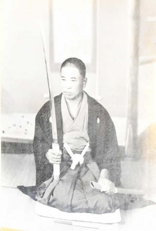 刀を見つめる藤田友治郎（藤田家提供）