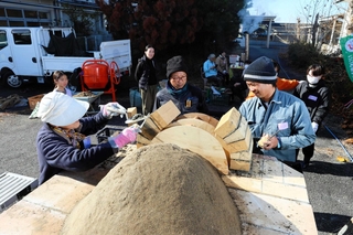 れんがを積み上げてピザ窯を作り上げていくワークショップ参加者＝三木市志染町井上