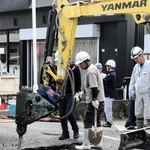 陥没でできた穴を掘り、原因を調べる作業員ら＝三木市府内町