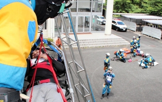 担架ごと吊り下ろされる救助者役＝丹波市山南町谷川
