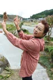 日本舞踊の舞のようにしてジネンジョを持つ眞造芽子さん＝三田市母子