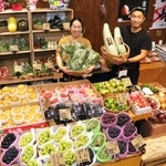 「にじ屋Ｓａｎｄａ　ｂａｓｅ」を開いた片山慶彦さん（右）。所狭しと青果が並ぶ＝三田市西山２の８の１９