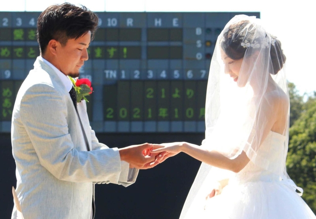 結婚指輪を交換する小牧顕士郎さん（左）と愛さん＝三田市三輪