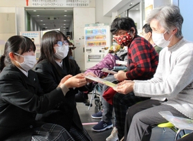 デイサービス利用者に祝い箸を手渡す有馬高校生＝三田市川除