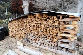 うずたかく積まれた、たき火用のまき＝三田市野外活動センター