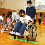 児童は車いすに乗る怖さや押す大変さを体験した＝高平小学校