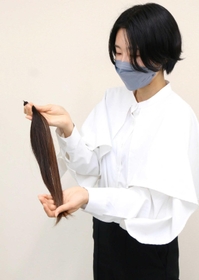 カットした４０センチの髪を持つ筆者＝三田市三輪２