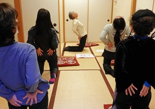 ヨガのポーズを取る参加者ら＝ウッディタウン市民センター