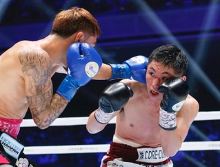 ２回、アンソニー・オラスクアガ選手（左）のパンチをよける加納陸選手＝両国国技館