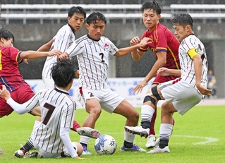 神戸弘陵の選手と激しくボールを奪い合う三田学園の選手＝９日午後、三木市の三木総合防災公園（撮影・斎藤雅志）