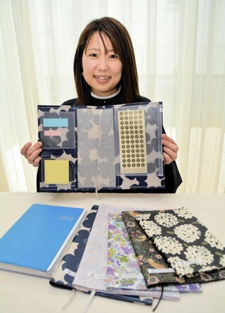 教員向け手帳カバーを作った小坂尚子さん。付箋や書類などを収納できる＝三田市ゆりのき台