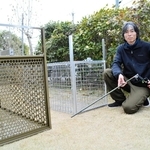 サル捕獲用のおりを前にする三木清雅さん＝三田市内