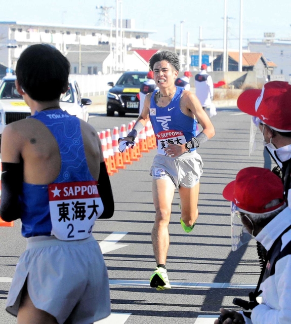 トップで４区にたすきをつなぐ石原翔太郎選手＝１月２日、箱根駅伝往路平塚中継所（代表撮影）