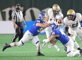 アメフトの日本選手権でタックルを見舞う関学大の野村選手（左）＝東京ドーム