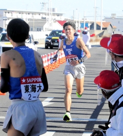 トップで４区にたすきをつなぐ石原翔太郎選手＝１月２日、箱根駅伝往路平塚中継所（代表撮影）